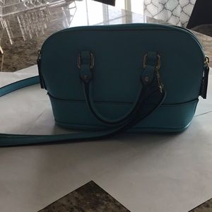 Light blue purse with detachable string.